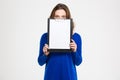 Pretty young woman covered her face with blank clipboard Royalty Free Stock Photo