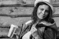 Pretty young woman in cowboy hat. Black and white portrait of attractive girl in jeans jacket on wooden fence background. Royalty Free Stock Photo