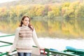 Pretty young woman on a deck above a river Royalty Free Stock Photo