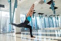 Pretty young woman doing fly yoga stretching exercises  in fitness training  gym. Health, fly yoga concept Royalty Free Stock Photo