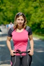 Pretty young woman doing rollerskate on a track