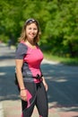 Pretty young woman doing rollerskate on a track