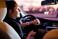 Pretty, young woman driving her modern car