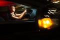 Pretty, young woman driving her modern car at night, in a city Royalty Free Stock Photo