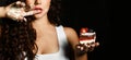 Pretty young woman eating birthday chocolate piece of cake with raspberry fruits celebrating