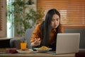 Pretty young woman eating a piece of pizza and watching movie on laptop. Takeaway, fast food and domestic life Royalty Free Stock Photo