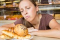 Pretty young woman eating sweets in the cafe. Bad habits. Health Royalty Free Stock Photo