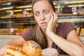 Pretty young woman eating sweets in the cafe. Bad habits. Health Royalty Free Stock Photo