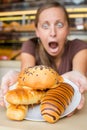 Pretty young woman eating sweets in the cafe. Bad habits. Health Royalty Free Stock Photo