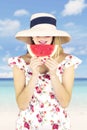 Pretty young woman eating watermelon on beach Royalty Free Stock Photo