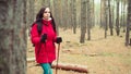 A pretty young woman is engaged in the nordic walking in woods. Royalty Free Stock Photo