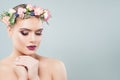 Pretty young woman face closeup portrait. Girl in spring flowers wreath. Facial treatment, anti aging and skin care Royalty Free Stock Photo