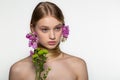 Pretty young woman with fresh spring look, wonderful hair, nice makeup, flowers near her face and in hair. Beauty and Royalty Free Stock Photo