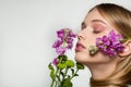 Pretty young woman with fresh spring look, wonderful hair, nice makeup, flowers near her face and in hair. Beauty and Royalty Free Stock Photo