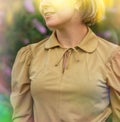 Happy woman in buddleia flowers field in luxurious gold dress.Young woman in gold dress standing in flowers field Royalty Free Stock Photo