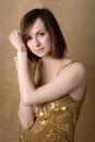 Pretty Young Woman in Gold Dress with Gold Watch