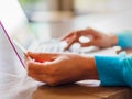 Pretty Young woman hands holding a credit card and using laptop computer for online shopping. Royalty Free Stock Photo