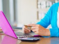 Pretty Young woman hands holding a credit card and using tablet, smartphone and laptop computer for online shopping. Royalty Free Stock Photo