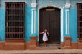 A pretty young woman with hat located at the door of an old colonial house in the colonial town of Trinidad Cuba Royalty Free Stock Photo