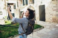 Pretty young woman having fun in the city in Europe in evening with camera Royalty Free Stock Photo