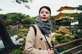 Pretty young woman having fun in kinkakuji kyoto