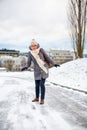 Pretty, young woman having troubles walking on an icy