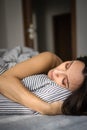 Pretty, young woman in her bed, fast asleep