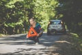 Pretty, young woman with her car broken down by the roadside Royalty Free Stock Photo