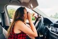 Reckless woman putting mascara in car