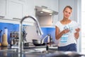 Pretty, young woman in her kitchen, fixing lunch Royalty Free Stock Photo