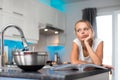 Pretty, young woman in her  kitchen Royalty Free Stock Photo