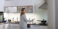 Pretty, young woman in her modern bright kitchen Royalty Free Stock Photo