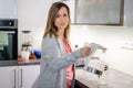 Pretty, young woman in her modern bright kitchen Royalty Free Stock Photo