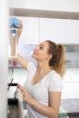 Pretty, young woman in her modern,  bright kitchen Royalty Free Stock Photo