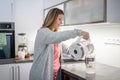 Pretty, young woman in her modern bright kitchen Royalty Free Stock Photo