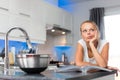 Pretty, young woman in her modern, clean and bright kitchen Royalty Free Stock Photo