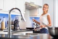 Pretty, young woman in her modern kitchen Royalty Free Stock Photo