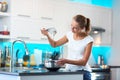 Pretty, young woman in her modern kitchen Royalty Free Stock Photo