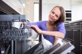 Pretty, young woman in her modern and well equiped kitchen