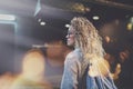 Pretty young woman hipster in stylish clothing wearing eye glasses traveling in the european night city. Bokeh and