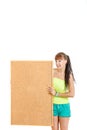 Pretty young woman holding blank cork board smiling Royalty Free Stock Photo