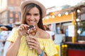 Pretty young woman holding delicious sweet bubble waffle with ice cream