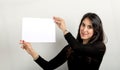 Portrait of a young woman holding a banner over white background Royalty Free Stock Photo