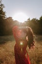 Pretty young woman holding her hair by hands and posing on a camera on the middle of wheat field Royalty Free Stock Photo