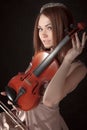 Pretty young woman holding a violin Royalty Free Stock Photo