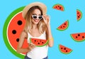 Pretty young woman with juicy watermelon on light blue background, stylish collage design. Summer season