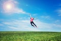 Pretty young woman jumping on green grass Royalty Free Stock Photo