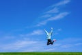 Pretty young woman jumping on green grass Royalty Free Stock Photo