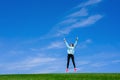 Pretty young woman jumping on green grass Royalty Free Stock Photo