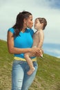 Pretty young woman kissing a cute boy Royalty Free Stock Photo